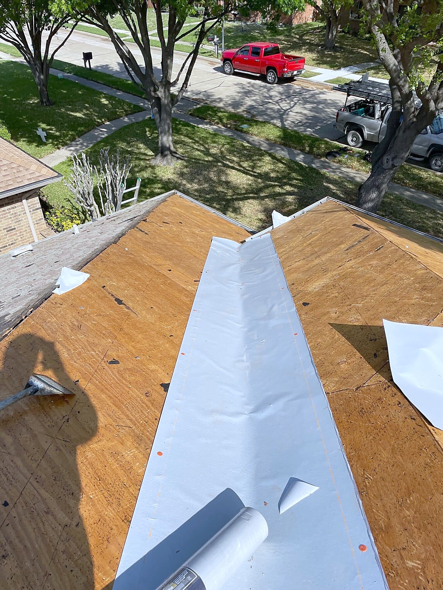 White ice and water membrane laid in a valley on new plywood decking